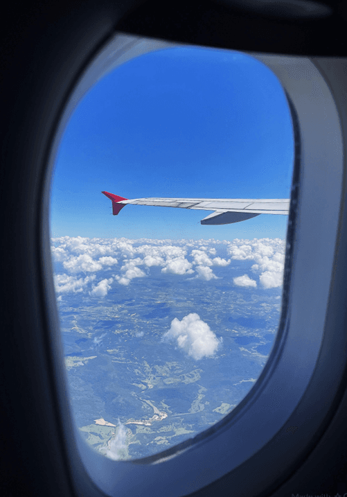 Flight Above the Clouds β Jetliner Wing Window View