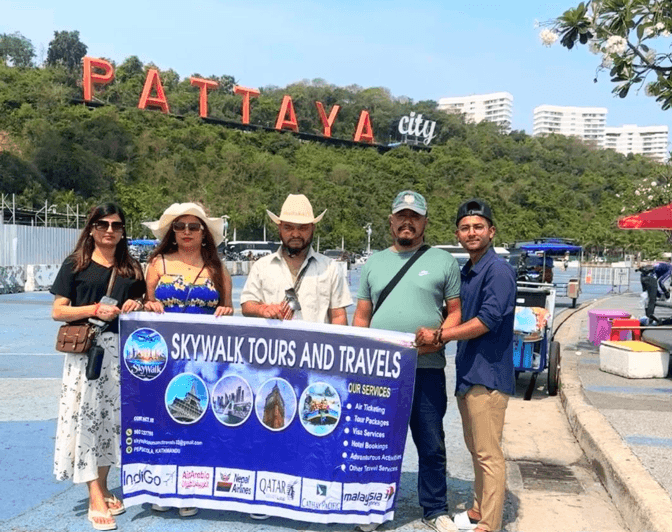SkyWalk Travelers at Pattaya City Hill Sign